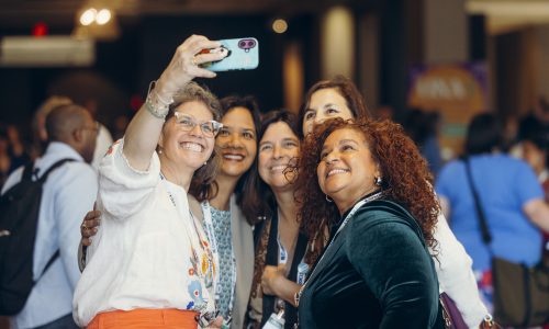 Attendees take a selfie at ONA25